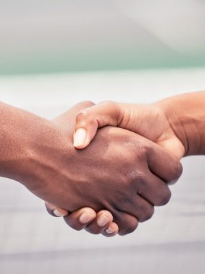Closeup, handshake and sport for support, teamwork or respect outdoor at tennis court with diversit